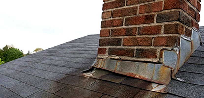 Rust wash staining a roof below failed chimney flashing